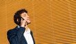 © ADDICTIVE STOCK - Businessman on a phone call outdoors in sunlight