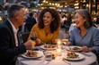 © Juan - Multigenerational friends enjoying dinner together and clinking wine glasses at outdoor restaurant