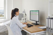 © Studio Romantic - Doctor in office views spreadsheet records on computer. Female physician updates patient information for analysis at a tidy desk in a modern clinic. Clear concept of medical data management.
