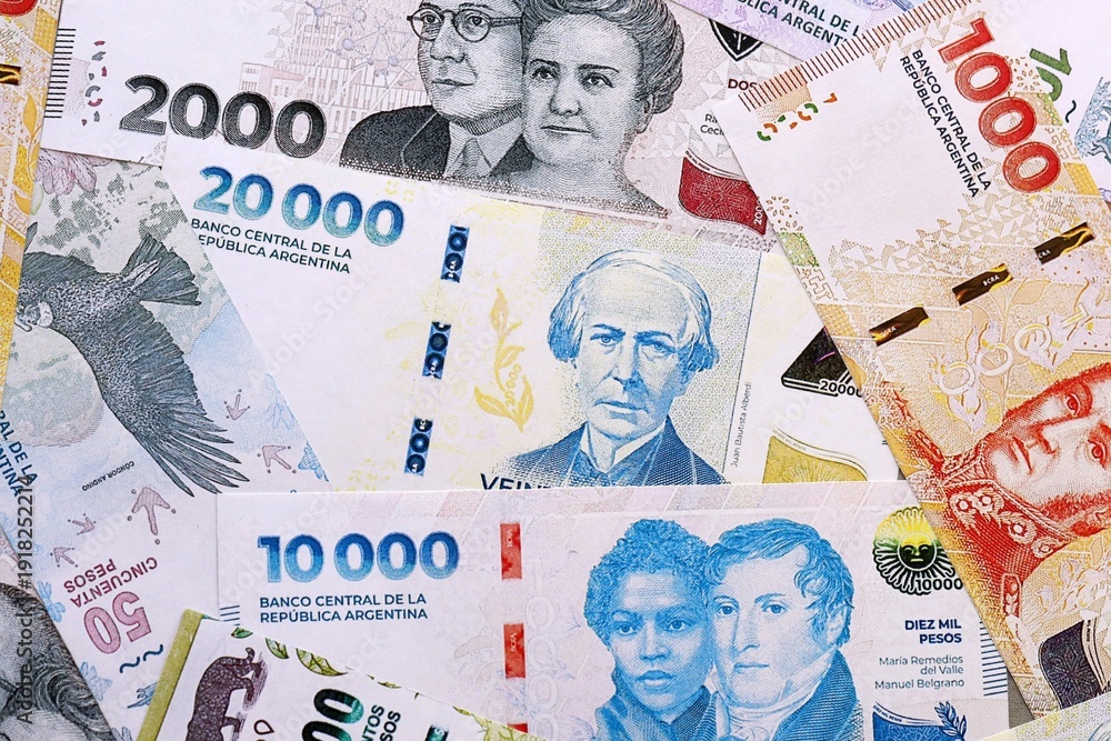 Argentine peso money bills pile on table. Argentina banknotes of ARS ...