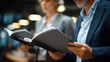 © Kateryna - Faceless people reading folders together in office environment collaborative review team documentation workplace cooperation business analysis professional collaboration