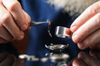 © New Africa - Senior man fixing mechanism of vintage wrist watch at mirror table, closeup