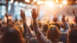 © Busayo - Professional conference audience raising hands  to ask questions during business presentation,hands of people raised at a concert