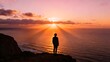 © Dzikri Design - Solitary figure standing on beach facing vibrant sunset over ocean