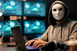 © DC Studio - Anonymous man with white mask types on laptop surrounded by multiple monitors displaying system access visuals. Portrait of hacker at desk, attempting security breach on private company software.