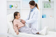 © New Africa - Doctor checking little girl with stethoscope in hospital