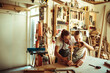 © Davor - Father and daughter building wooden toy in home workshop