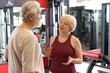 © New Africa - Senior couple in sportswear talking in gym