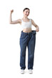 © New Africa - Woman wearing big jeans on white background