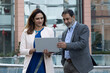 © Pix4Ads - Indian business people using laptop in a city in front of the office building. Concept of a senior manager and employee using digital technology