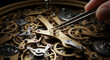 ©  lado deginer - Close up of a hand using tweezers to adjust intricate clockwork gears and mechanisms in a vintage timepiece