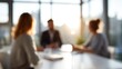 © Enigma - Business team discussing new ideas during a blurred meeting in a bright corporate office environment