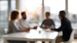 © Enigma - Business people meeting in a modern office, collaborating on a project, blurred background for concept of teamwork and discussion