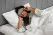 © Pixel-Shot - Beautiful young African-American woman in pajamas and mask sleeping on bed in bedroom. World Sleep Day