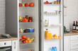 © Pixel-Shot - Open fridge full of fresh food in modern kitchen, closeup