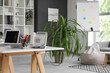 © Pixel-Shot - Workplace with modern laptop, houseplant and shelving unit in stylish office