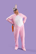 © Pixel-Shot - Senior man in Easter bunny costume with plush carrot on lilac background