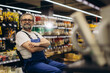 © Roman - Experienced hardware store worker sitting, smiling in aisle