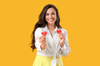 © Pixel-Shot - Pretty young woman with paper hearts on yellow background