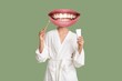 © Pixel-Shot - Young woman with mouth instead of head holding tooth brush and paste on green background