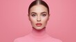 © Ant - A close-up portrait of a woman with flawless makeup, wearing a pink turtleneck sweater against a matching pink background.