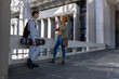 © wavebreak3 - Teen skateboarder leaning on concrete railing while African-American woman talking on smartphone