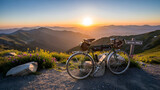 Adventure bike with bags standing on a rocky trail at the summit during sunset