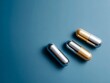 © Evgeniia - Minimalistic composition of capsules on blue background. Concept of hormone therapy for men, testosterone supplements, and male fertility treatment