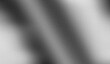 © Anas2003 - Abstract grainy background featuring diagonal bands of diffused light and deep shadow in monochrome grayscale tones creating texture.