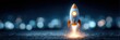 © Mariia - Startup rocket launch on dark background symbolizing business growth, innovation and successful project start. Horizontal banner with copy space for marketing, investment and technology concepts