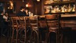 © Justlight - Evening pub scene with wooden stools in sharp focus and ambient soft lighting highlighting the welcoming intimate atmosphere of a local gathering spot.