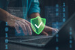 © Looker_Studio - Cybersecurity protection concept with secure shield icon over laptop and source code. Data security, encryption, privacy protection and network defense for safe digital technology and IT systems.