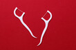 © splitov27 - Floss toothpicks on red background. Dental hygiene concept. Top view