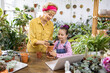 © sofiko14 - A woman and a young girl are potting a succulent plant, enjoying a fun gardening activity together