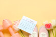 © Pixel-Shot - Composition with calendar of April, beautiful tulip flowers, shoes and dumbbells on color background