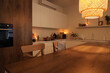 © Pixel-Shot - Interior of kitchen with counters, burning candles and glowing lamp in evening