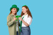 © Pixel-Shot - Beautiful women with beer on blue background. St. Patrick's Day celebration