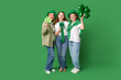 © Pixel-Shot - Beautiful women with clovers on green background. St. Patrick's Day celebration