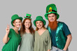 © Pixel-Shot - Group of people in hats on light background. St. Patrick's Day celebration