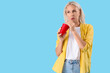 © Pixel-Shot - Thoughtful mature woman with cup of soda on blue background