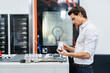 © Westend61 - Businessman examining workpiece in a factory