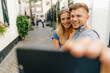 © Westend61 - Netherlands, Maastricht, happy young couple taking a selfie in the city