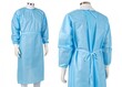 © ArtStock - Blue disposable medical gown with long sleeves, ties. Protective clothing for health care professionals. Healthcare worker wears protective garment