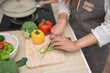 © WMSTUDIO - Fresh Vegetable Preparation in Modern Kitchen with Person Slicing Cucumbers and Colorful Peppers for Healthy Meal Preparation