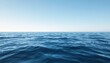 © Vella - Calm ocean waves under clear blue sky with gentle ripples on the water's surface
