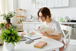 © LIGHTFIELD STUDIOS - Woman enjoying a productive day in her stylish home office