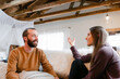 © Leah Flores/Stocksy - Smiling Couple have a Conversation Together on Their Couch