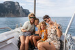 © Alvaro Lavin/Stocksy - Happy couple and daughters making funny faces on a boat trip