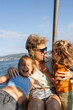 © Alvaro Lavin/Stocksy - Mother and daughters laughing together on sailboat trip
