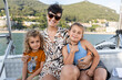 © Alvaro Lavin/Stocksy - Happy family smiling and posing for a photo while enjoying a boat trip